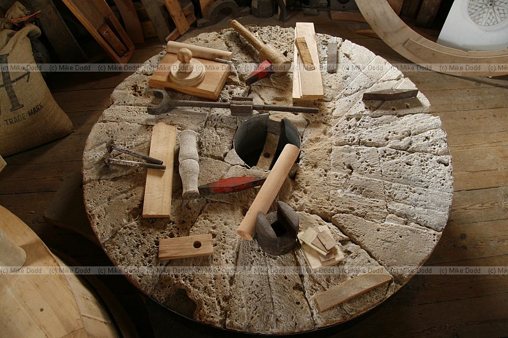 Millstone made out of pieces of french burrstone a kind of quartzite also showing various windmill mill tools